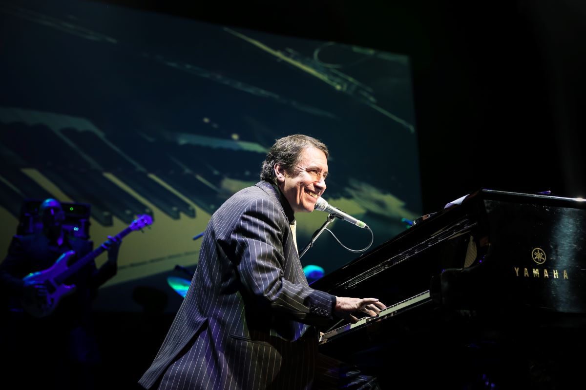 Jools Holland on stage playing piano